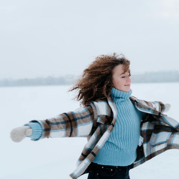 Joyful woman feeling energetic and vibrant in nature.